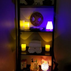 Rising Lotus Holistic - Himalayan salt lamp, aromatherapy diffuser, candles, and towels. Setting the area for relaxation and rejuvenation.