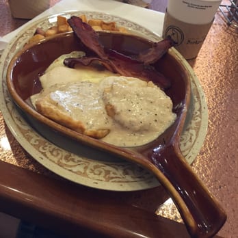 Another Broken Egg Cafe - Classic Biscuits and Gravy meal with two eggs over easy, seasoned country potatoes, and two strips of extra crispy bacon! - Breakfast & Brunch Near Me - Indianapolis, Indiana