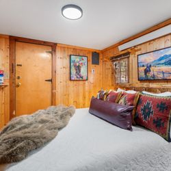 Hillside Country Cabins - Comfortable beds and rustic charm await in the bedroom at Hillside Country Cabins in the Black Hills.