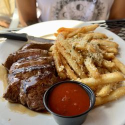 Coasters Crossing - Frites. The steak was tender and the garlic was piled on the fries!