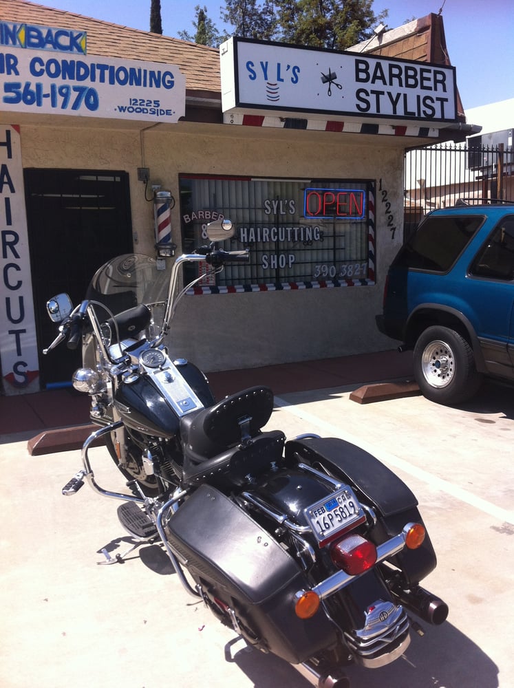 Syl's Hair Cutting Shop Logo