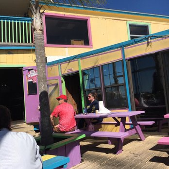 Seaside Inn - people sitting at picnic tables in front of a colorful building - Seafood Near Me - New Port Richey, Florida Seaside Inn - people sitting at picnic tables in front of a colorful building - Seafood Near Me - New Port Richey, Florida
