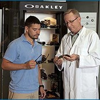 Somers Eye Center - Our optician Rick Moreno helps a patient choose the best fit and style of Oakley sunglasses. - Optometrists Near Me - Kansas City, Missouri Somers Eye Center - Our optician Rick Moreno helps a patient choose the best fit and style of Oakley sunglasses. - Optometrists Near Me - Kansas City, Missouri