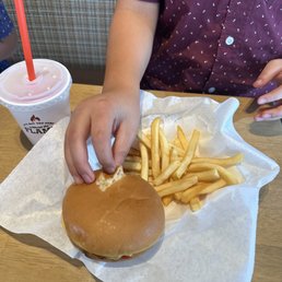 Kids burger, fries, and drink with candy as a dessert Kids burger, fries, and drink with candy as a dessert
