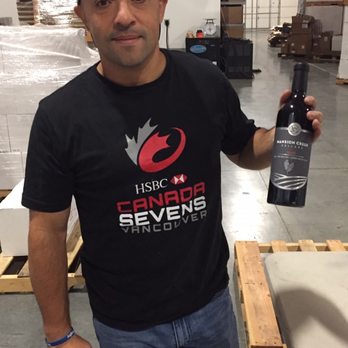 Mansion Creek Cellars - a man holding a bottle of wine - Wine Tasting Room Near Me - Seattle, Washington