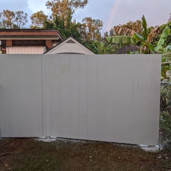 Mila Construction - a white fence with a rainbow in the background - General Contractors Near Me Mila Construction - a white fence with a rainbow in the background - General Contractors Near Me