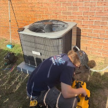 Extreme Heating & Cooling - technician clearing a drain line on a maintenance - Heating & Air Conditioning/HVAC Near Me - Navarre, Florida