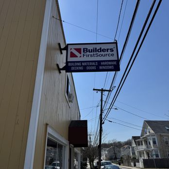 Builders FirstSource - Hanging Builders FirstSource exterior sign mounted on a storefront, listing building materials, hardware, decking, doors, and... - Building Supplies Near Me - Salem, Massachusetts Builders FirstSource - Hanging Builders FirstSource exterior sign mounted on a storefront, listing building materials, hardware, decking, doors, and... - Building Supplies Near Me - Salem, Massachusetts