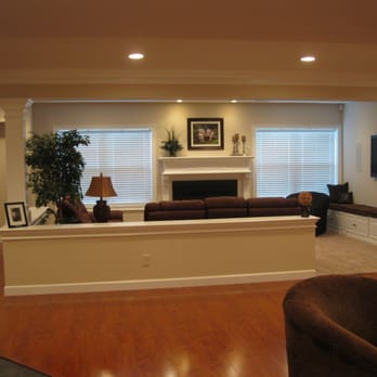 Dan Weber General Construction - Basement build-out with custom fireplace mantle and bench seating. - General Contractors Near Me