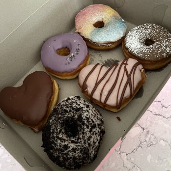 Dough Joy - Top row - Bavarian Cream, Lavender Vanilla, Pride Bottom row - Cookies & Creme, Chocolate Strawberry, French Toast - Donuts Near Me - Seattle, Washington Dough Joy - Top row - Bavarian Cream, Lavender Vanilla, Pride Bottom row - Cookies & Creme, Chocolate Strawberry, French Toast - Donuts Near Me - Seattle, Washington