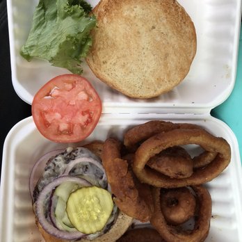 Archies Grill - Small overcooked burger on an over sized bun and overcooked onion rings. $0.50 for that onion slice $20.63!!!! - American Near Me - Shelburne, Vermont