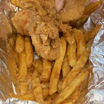 Crispy Dough Pizzeria - a person grabbing a piece of fried chicken - Pizza Near Me - Boston, Massachusetts