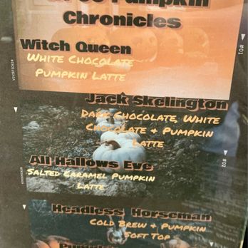Wild Pine - WPCC Pumpkin Chronicles Menu - A printed menu board from Wild Pine Coffee in Peoria, AZ, displays various pumpkin-flavored coffee drinks. The menu includes options such as Witch Queen with white chocolate and pumpkin latte, Jack Skellington with dark and white chocolate plus pumpkin latte, and All Hallows Eve with salted caramel pumpkin latte. The board has a background image of pumpkins and fall decorations, with text in bold and handwritten fonts highlighting the drink names and ingredients. - Coffee & Tea Near Me - Peoria, Arizona