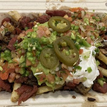 Señor Sisig - Fries smothered in nacho cheese, sweet pork, salsa, guac, cilantro cream & jalapeños. SO GOOD - Filipino Near Me Señor Sisig - Fries smothered in nacho cheese, sweet pork, salsa, guac, cilantro cream & jalapeños. SO GOOD - Filipino Near Me