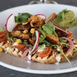 White Buffalo - Chicken Huarache (Flatbread) chipotle red bean puree, arugula, veggies, cilantro lime crema, cotija cheese, and tomatillo avocado salsa