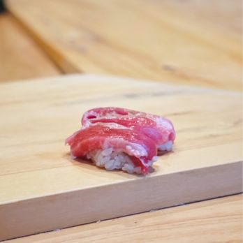 Itosugi Kappo Cuisine - a piece of sushi on a cutting board - Japanese Near Me - Vancouver, British Columbia Itosugi Kappo Cuisine - a piece of sushi on a cutting board - Japanese Near Me - Vancouver, British Columbia