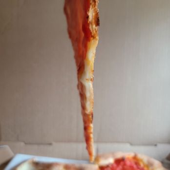 Gino's Pizzeria - Side view pizza slice - Pizza Near Me - Bronxville, New York Gino's Pizzeria - Side view pizza slice - Pizza Near Me - Bronxville, New York