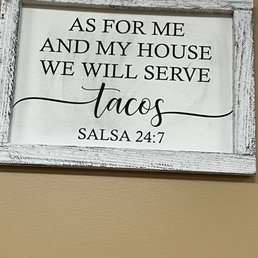 a sign saying as for me and my house we will serve tacos salsa
