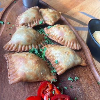 Fogo de Chão - Brazilian Empanadas: Flaky pastry, seasoned Picanha, onions, chimichurri aioli - Brazilian Near Me - Garden City, New York Fogo de Chão - Brazilian Empanadas: Flaky pastry, seasoned Picanha, onions, chimichurri aioli - Brazilian Near Me - Garden City, New York