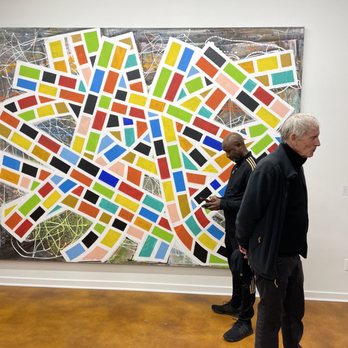 Simone DeSousa Gallery - The artist Robert Sestok in the foreground. Guy behind him graciously stepped back away from the middle of the painting - Art Galleries Near Me - Detroit, Michigan Simone DeSousa Gallery - The artist Robert Sestok in the foreground. Guy behind him graciously stepped back away from the middle of the painting - Art Galleries Near Me - Detroit, Michigan