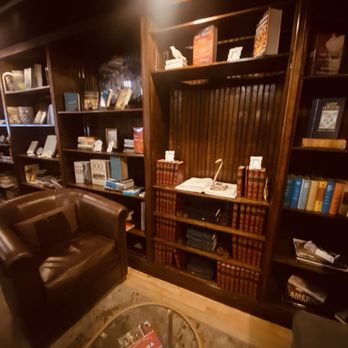The Reading Room - Seating area with bookshelves full of books and cool things to look at. - Lounges Near Me - Omaha, Nebraska