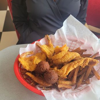 Flying Burger - 2 fish, 4 shrimp, 2 hushpuppies, on a bed of home cut fries. - Burgers Near Me - East Camden, Arkansas Flying Burger - 2 fish, 4 shrimp, 2 hushpuppies, on a bed of home cut fries. - Burgers Near Me - East Camden, Arkansas