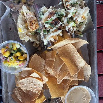 Tiki Docks Riverview - Blackened, grouper tacos with nachos. You get three tacos. It was delicious. Two of us ordered it and we were both satisfied. - Salad Near Me - Riverview, Florida