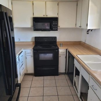 Rock Star Finishes - a kitchen with white cabinets and black appliances - General Contractors Near Me - Henderson, Nevada Rock Star Finishes - a kitchen with white cabinets and black appliances - General Contractors Near Me - Henderson, Nevada