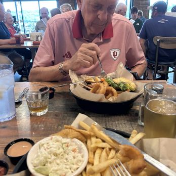 Rafters Food & Spirits - Ralpue digging into his tenderloin sandwich. - Bars Near Me - Nashville, Indiana Rafters Food & Spirits - Ralpue digging into his tenderloin sandwich. - Bars Near Me - Nashville, Indiana