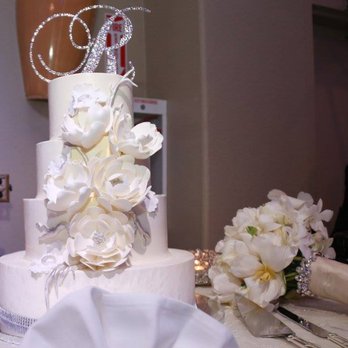 Some Crust Bakery - Each tier had a different flavor. The flowers were made hand made with fondant. - Bakeries Near Me - Claremont, California
