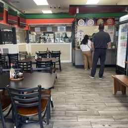 Cashier and serving counter up ahead. There's 6 tables of four on the left hand side. Cashier and serving counter up ahead. There's 6 tables of four on the left hand side.