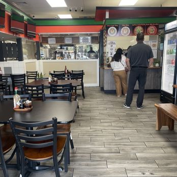 Sw8 Dada's Sizzling Sisig - Cashier and serving counter up ahead. There's 6 tables of four on the left hand side. - Food Trucks Near Me - Waipahu, Hawaii