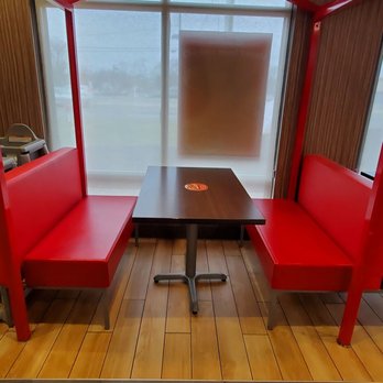 Jollibee - a red booth with a table and chairs - Fast Food Near Me - Edison, New Jersey