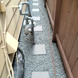 Coco's Nursery & Landscape - Leveling out removal of old pathway then at a simplistic loneliness pathway with erosion cloth beneath Black Star gravel
