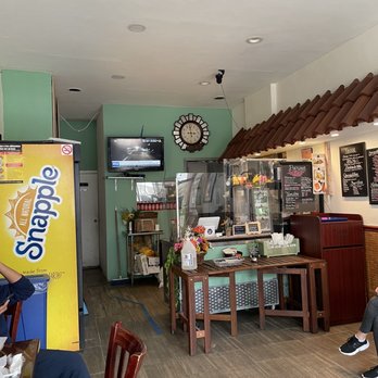 Ricas Pupusas & Mas - people sitting at tables in a restaurant - Salvadoran Near Me - Woodside, New York Ricas Pupusas & Mas - people sitting at tables in a restaurant - Salvadoran Near Me - Woodside, New York