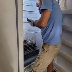 Maximum Appliance Repair - Detailed refrigerator repair in progress. We handle all major brands with care and professionalism.