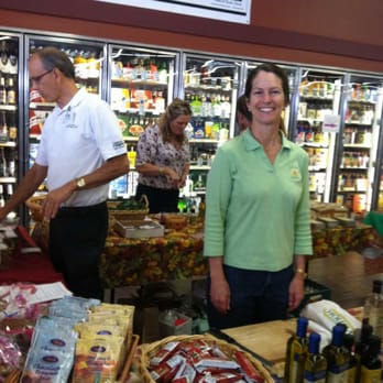 Holiday Market - a man and a woman standing in front of a display of food - Grocery Near Me - Redding, California