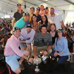 Apex Velo team accepting first place trophy at Best Buddies Challenge with Tom Brady and Julian Edelman.