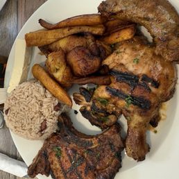 Parrillada Personal: grilled pork chops, grilled chicken, sausage. Sides of plantains and arroz con frijoles