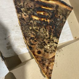A slice of BURNT PIZZA. Would YIU eat this crap. Never again - Worst pizza ever A slice of BURNT PIZZA. Would YIU eat this crap. Never again - Worst pizza ever