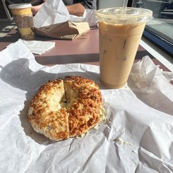 Coconut bagel with pineapple cream cheese and an iced coffee