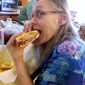Cuban Cafe - Sandy inhaling a Cuban Sandwich ... if ever a picture was worth 1,000 words! - Cuban Near Me - Pompano Beach, Florida