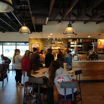 Starbucks - The drinks aren't made any faster if you crowd the delivery bar.  Someone should have told that to these people.  Not me. - Coffee & Tea Near Me - Davis, California