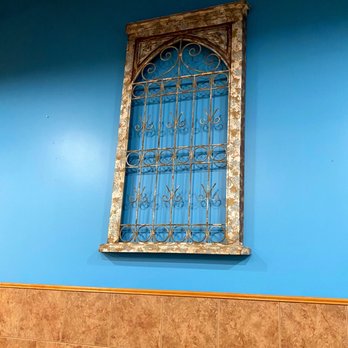 Caspian Mediterranean Grill - a blue wall with a window - Mediterranean Near Me - Ypsilanti, Michigan