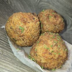 Three lightly battered and fried boudin balls.