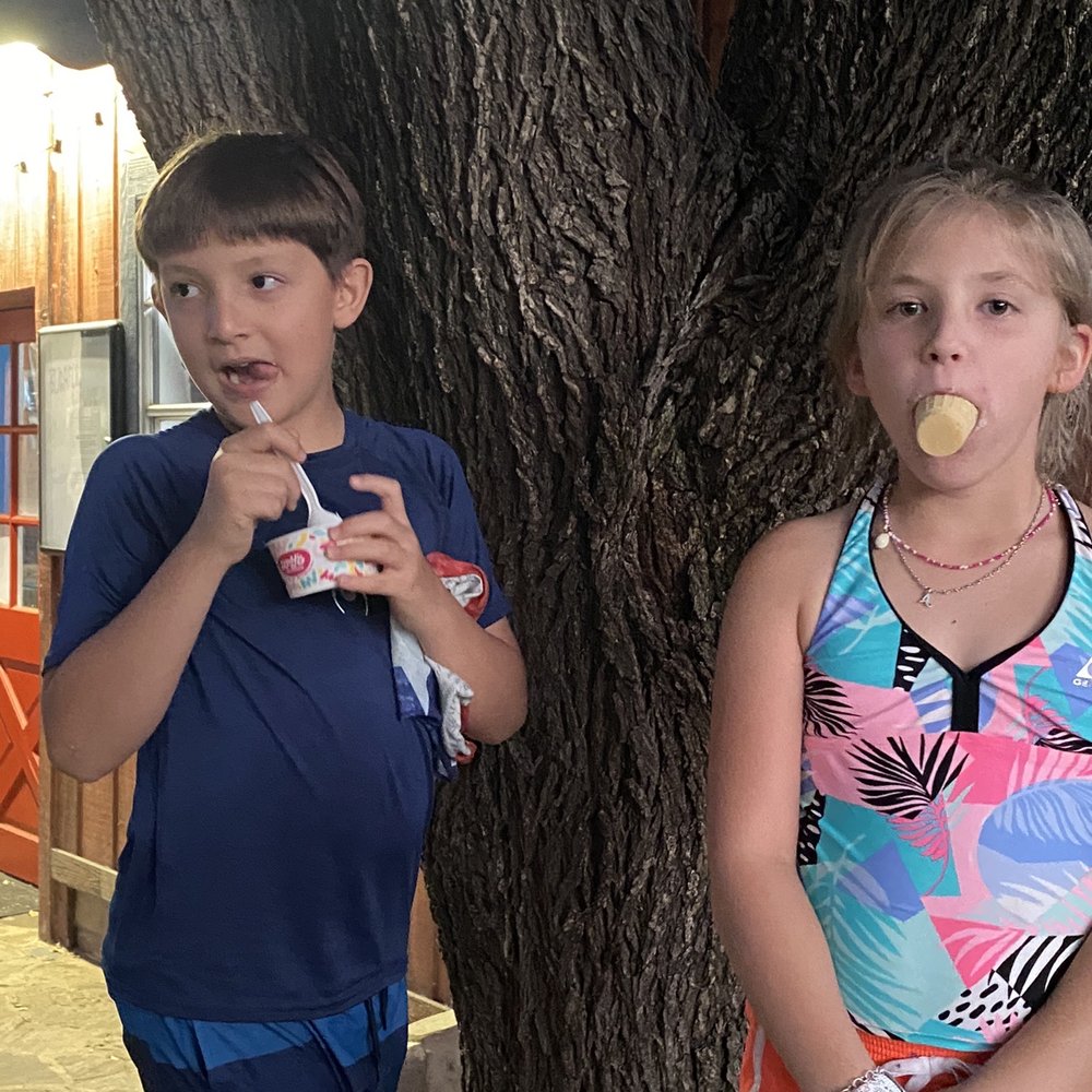 Monster Treats - two children standing next to a tree - Ice Cream & Frozen Yogurt Near Me - Wimberley, Texas