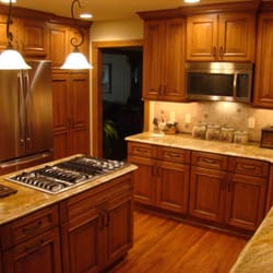 Straight A Builders Inc - Kitchen remodeling with new cabinets, countertop, backsplash tile.