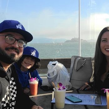 Luau Lounge - Family enjoining tropical drinks with a view of the SF Bay and Alcatraz - Sports Bars Near Me - San Francisco, California Luau Lounge - Family enjoining tropical drinks with a view of the SF Bay and Alcatraz - Sports Bars Near Me - San Francisco, California