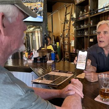 Mt Rushmore Brewing - This is Jim showing my husband, his walleye catch - Brewpubs Near Me - Custer, South Dakota
