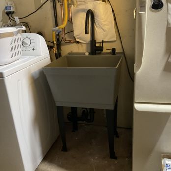 Murray Plumbing - Utility sink in garage, installed under tankless water heater - Plumbing Near Me